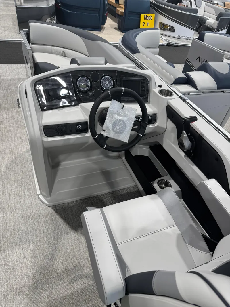 Slide: The Image of Interior of 2025 Avalon 2385 25 LSZ VRL boat, featuring modern steering console and seating. - 5