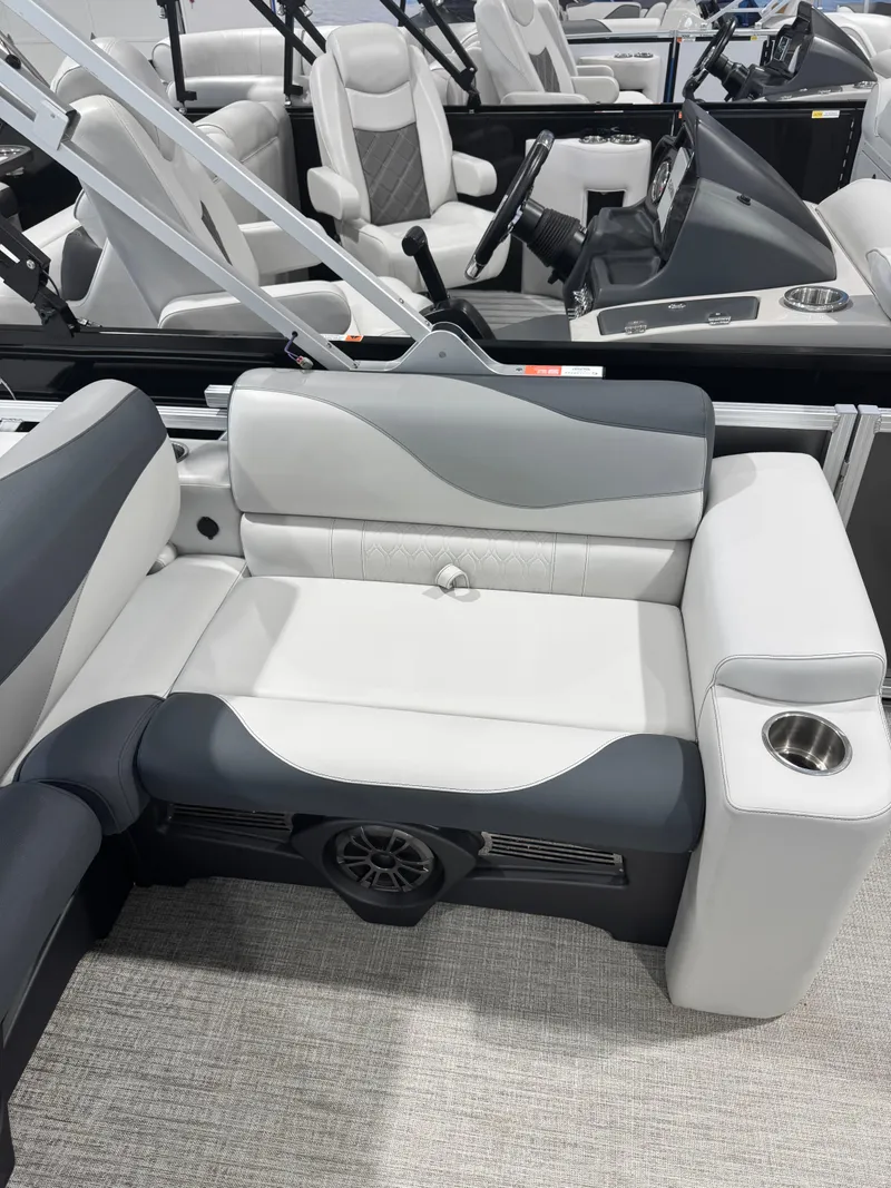 Slide: The Image of Luxurious seating in the 2025 Avalon 2385 25 LSZ VRL boat, featuring cup holder and speaker. - 8