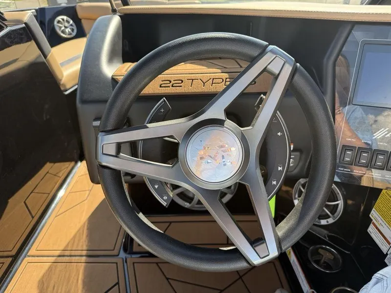 Slide: The Image of Steering wheel of 2023 ATX Surf Boats 22 TYPE-S with dashboard controls. - 13