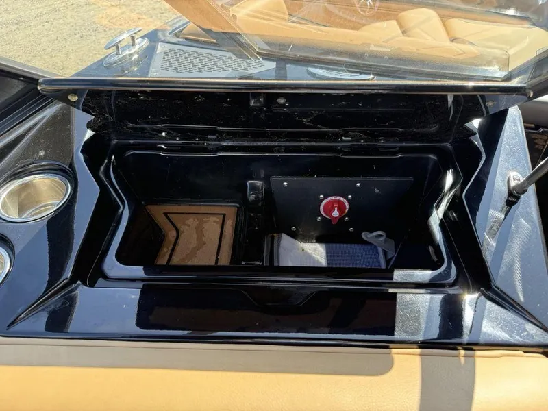 Slide: The Image of Open storage compartment in 2023 ATX Surf Boats 22 TYPE-S, featuring cup holders and control panel. - 15