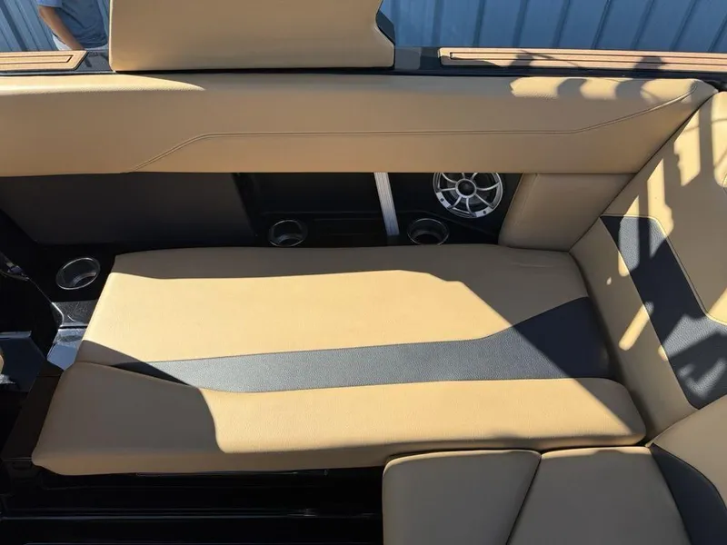 Slide: The Image of 2023 ATX Surf Boats 22 TYPE-S interior with tan seating and built-in speaker. - 16