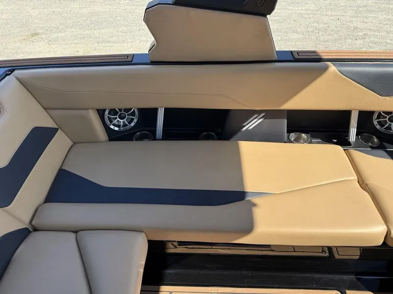 Slide: The Image of 2023 ATX Surf Boats 22 TYPE-S interior with tan and black seating, featuring built-in speakers. - 17