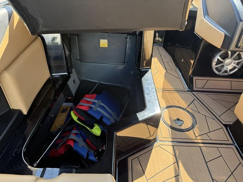 Slide: The Image of 2023 ATX Surf Boats 22 TYPE-S interior storage with life jackets and stylish flooring. - 20