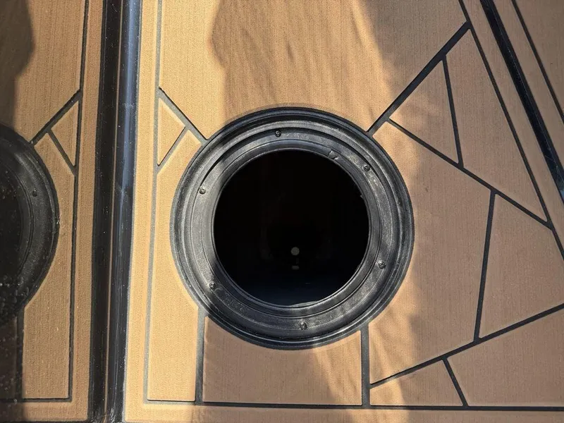 Slide: The Image of 2023 ATX Surf Boats 22 TYPE-S deck with geometric design and circular hatch. - 25