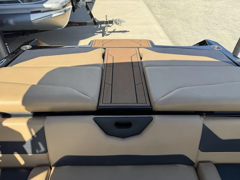 Slide: The Image of 2023 ATX Surf Boats 22 TYPE-S interior with tan and black seating, wood accents. - 26