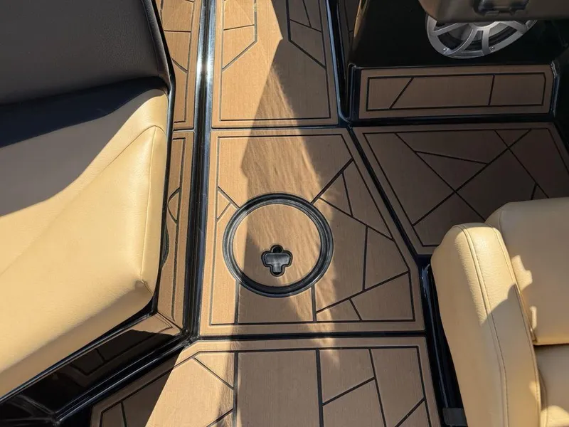 Slide: The Image of 2023 ATX Surf Boats 22 TYPE-S interior with tan seats and geometric flooring design. - 27