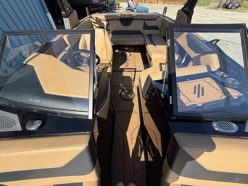 Slide: The Image of 2023 ATX Surf Boats 22 TYPE-S interior with tan and black seating, open cockpit view. - 35