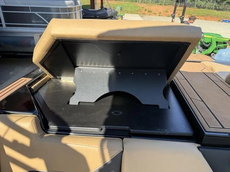 Slide: The Image of Open storage compartment on 2023 ATX Surf Boats 22 TYPE-S, featuring tan and black interior. - 37
