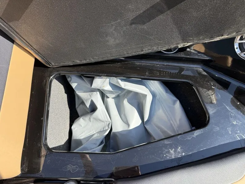 Slide: The Image of Storage compartment of 2023 ATX Surf Boats 22 TYPE-S, featuring a sleek black interior. - 9