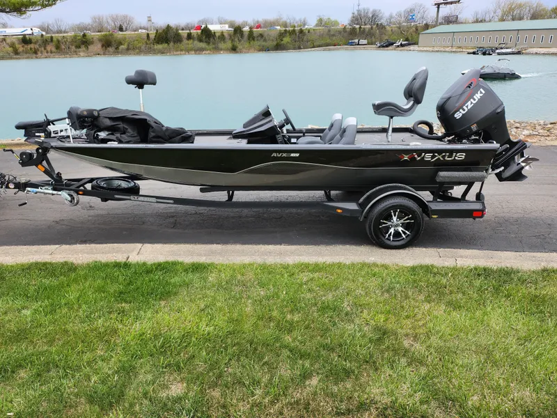 Slide: The Image of 2021 Vexus AVX189 boat with Suzuki motor on trailer by a lake. - 10