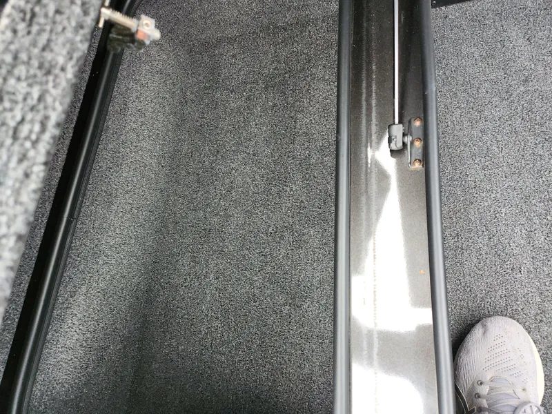 Slide: The Image of Interior view of a 2021 Vexus AVX189 boat, featuring carpeted flooring and metal rail. - 17