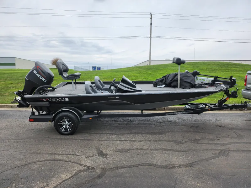 Slide: The Image of 2021 Vexus AVX189 fishing boat with Suzuki motor on trailer, parked outdoors. - 4