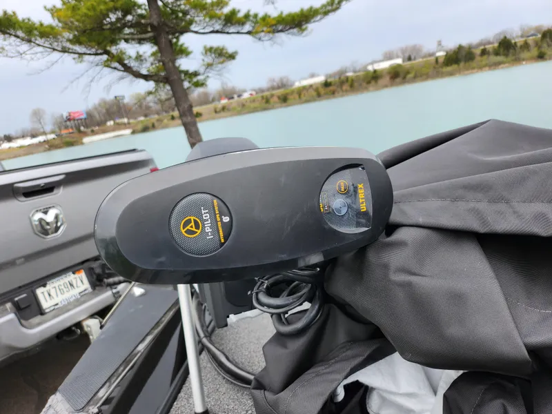 Slide: The Image of 2021 Vexus AVX189 boat with a covered motor near a lake and parked truck. - 8