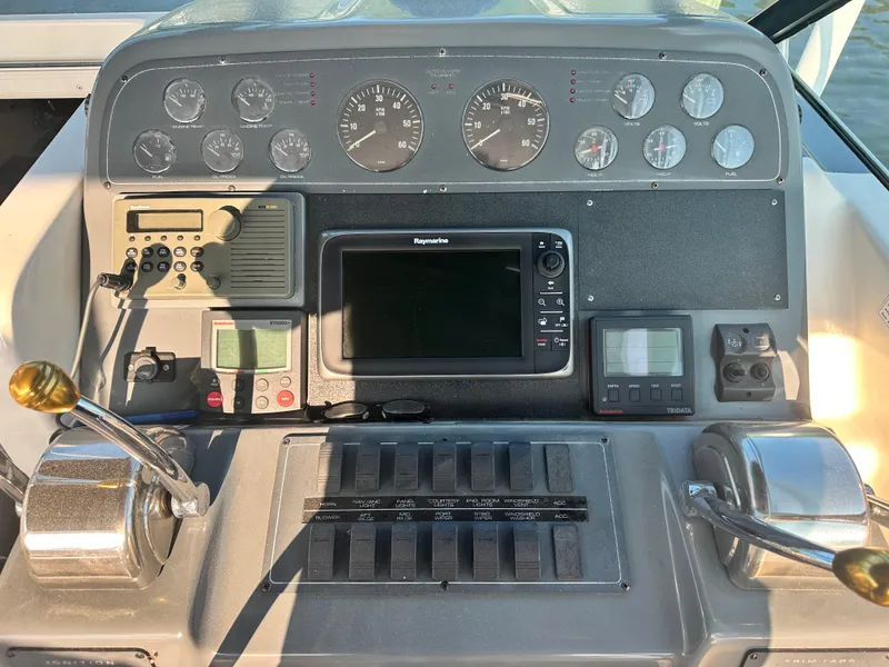 Slide: The Image of 1997 Tiara Yachts 3100 Open dashboard with gauges, controls, and navigation equipment. - 12