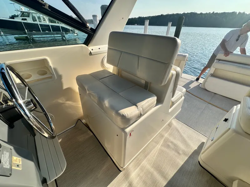 Slide: The Image of Interior of a 1997 Tiara Yachts 3100 Open, featuring helm seat and steering wheel. - 14