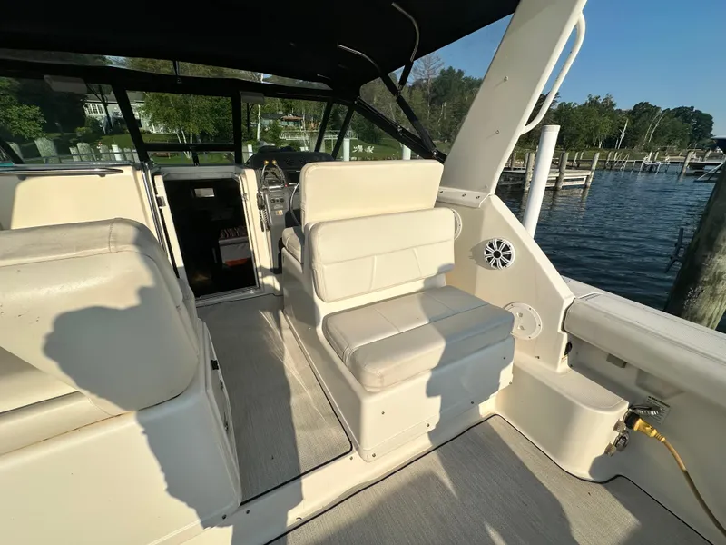 Slide: The Image of 1997 Tiara Yachts 3100 Open interior with white seating and waterfront view. - 15