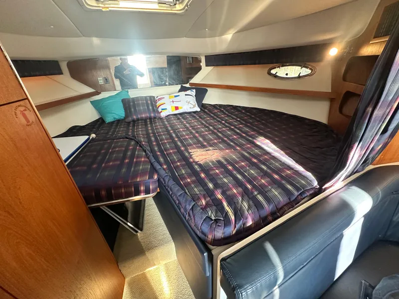 Slide: The Image of 1997 Tiara Yachts 3100 Open cabin interior with bed and wooden accents. - 18