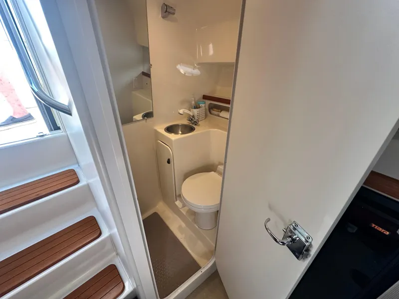 Slide: The Image of 1997 Tiara Yachts 3100 Open bathroom with compact sink and toilet. - 20