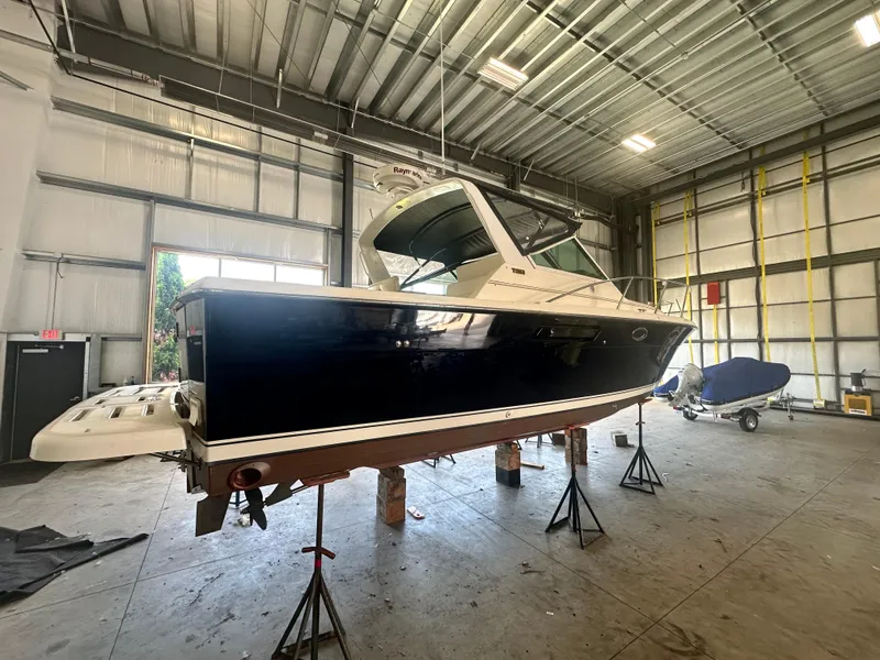 Slide: The Image of 1997 Tiara Yachts 3100 Open in a warehouse, elevated on stands. - 6