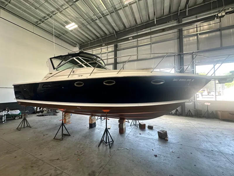 Slide: The Image of 1997 Tiara Yachts 3100 Open in a warehouse, elevated on stands. - 8