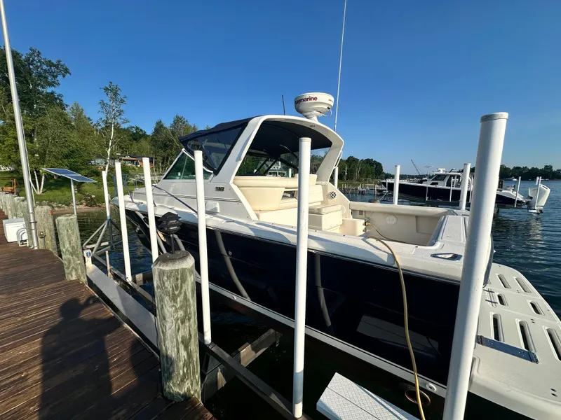 Slide: The Image of 1997 Tiara Yachts 3100 Open docked at a marina on a sunny day. - 9