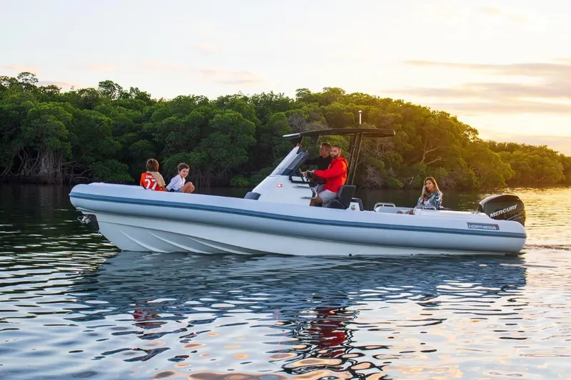 Slide: The Image of 2024 Northstar Orion 8 boat cruising on a calm river with passengers. - 10