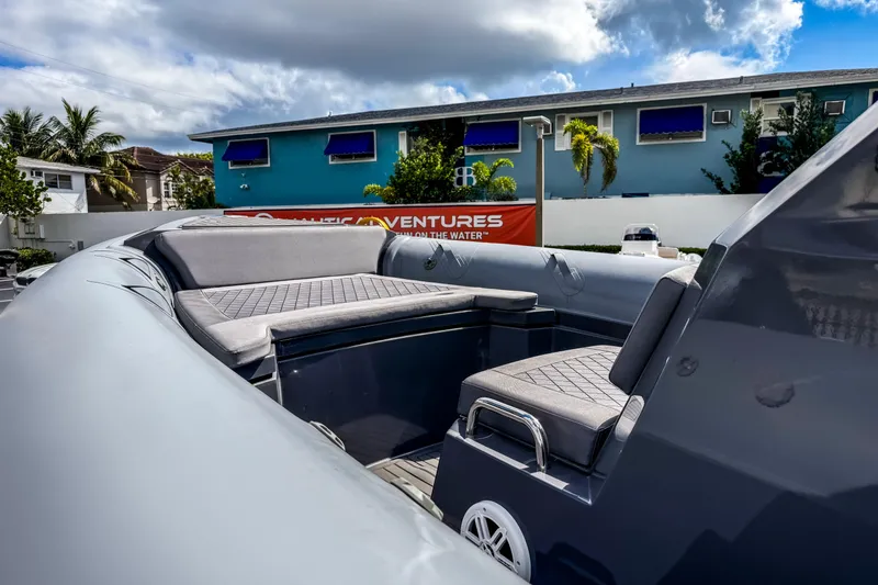 Slide: The Image of 2024 Northstar Orion 8 boat interior with cushioned seating, under a partly cloudy sky. - 4