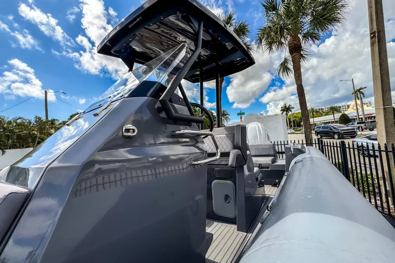 Slide: The Image of 2024 Northstar Orion 8 boat with sleek design, parked under palm trees, clear blue sky. - 9
