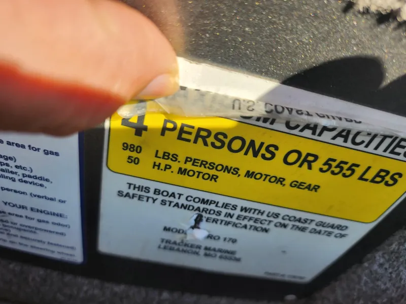 Slide: The Image of 2018 Tracker Pro 170 capacity label showing limits: 4 persons or 555 lbs, 50 HP motor. - 12