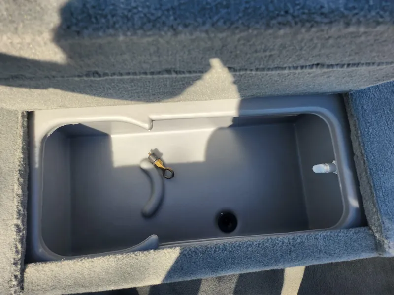 Slide: The Image of 2018 Tracker Pro 170 boat storage compartment with gray interior and key. - 14