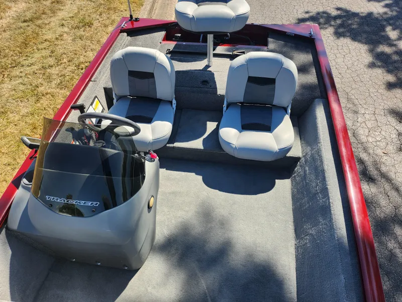 Slide: The Image of 2018 Tracker Pro 170 boat interior with three seats and steering console. - 17