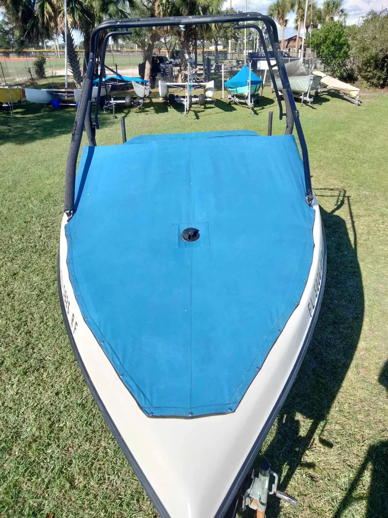 Slide: The Image of 2001 Tigé 21i boat with blue cover on grassy area. - 11