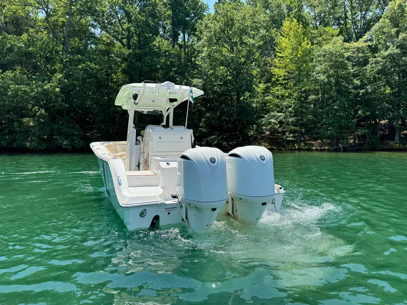 Slide: The Image of 2017 Sea Fox 288 Commander boat cruising on clear green water, surrounded by lush trees. - 10