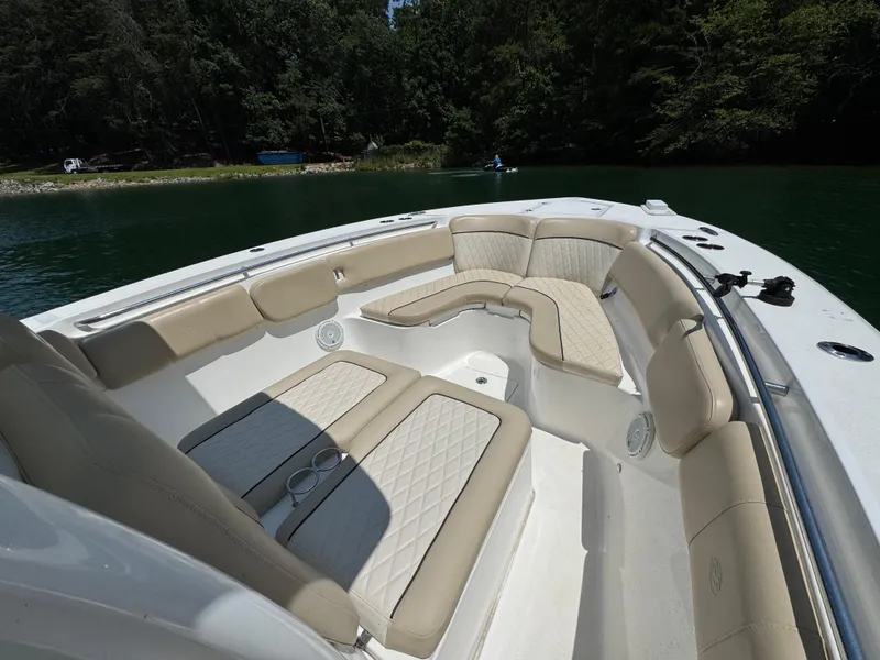 Slide: The Image of 2017 Sea Fox 288 Commander boat interior with beige seating, on a calm lake. - 13