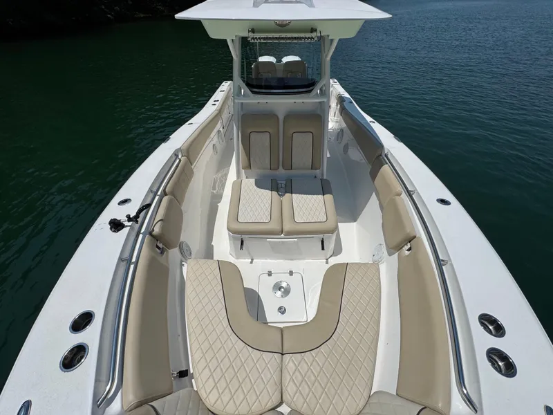 Slide: The Image of 2017 Sea Fox 288 Commander boat interior with beige seating on calm water. - 14