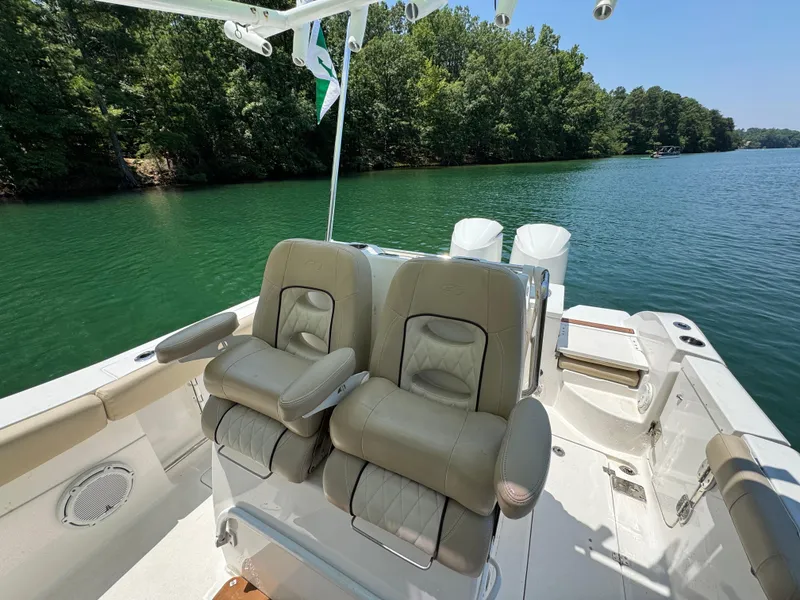 Slide: The Image of 2017 Sea Fox 288 Commander boat interior with dual seats on a serene lake. - 15