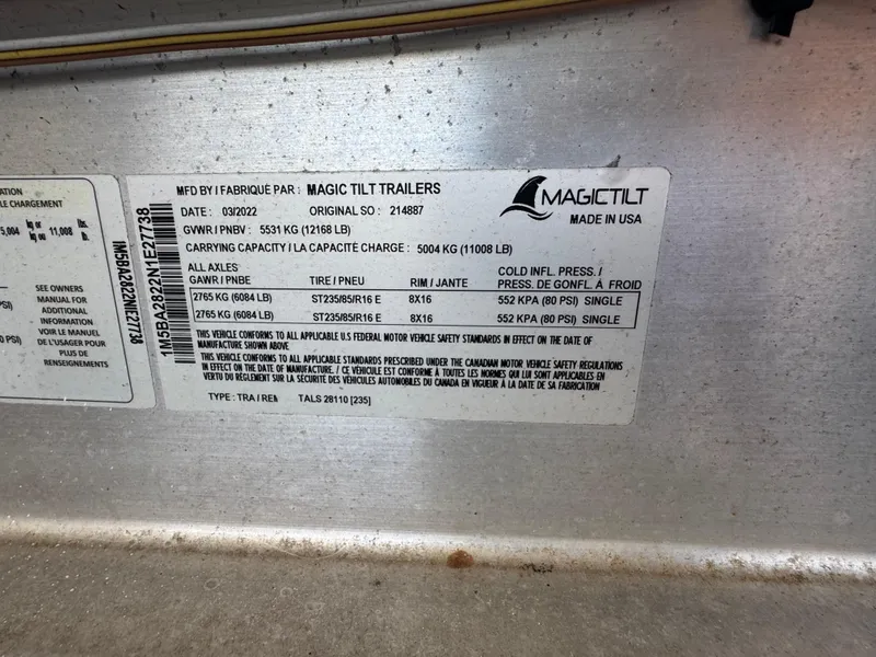 Slide: The Image of Label on Magic Tilt trailer showing specifications and tire pressure details. - 19