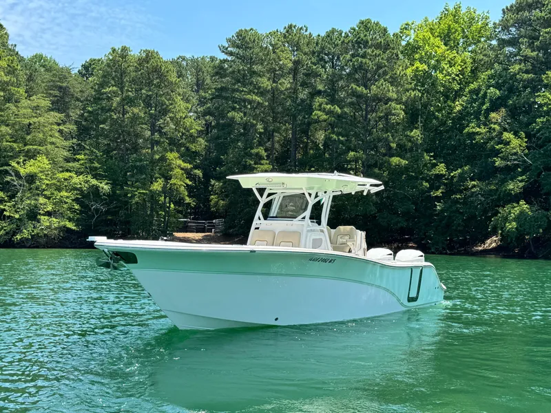 Slide: The Image of 2017 Sea Fox 288 Commander boat on a serene lake with lush green trees. - 4