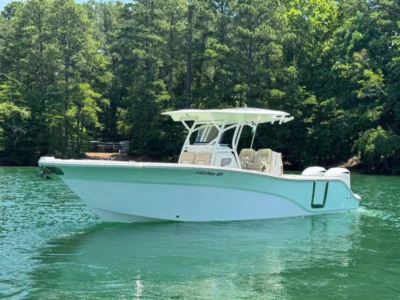 Slide: The Image of 2017 Sea Fox 288 Commander boat on a serene lake with lush green trees. - 5
