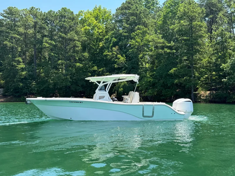 Slide: The Image of 2017 Sea Fox 288 Commander boat on a serene lake with lush green trees. - 6