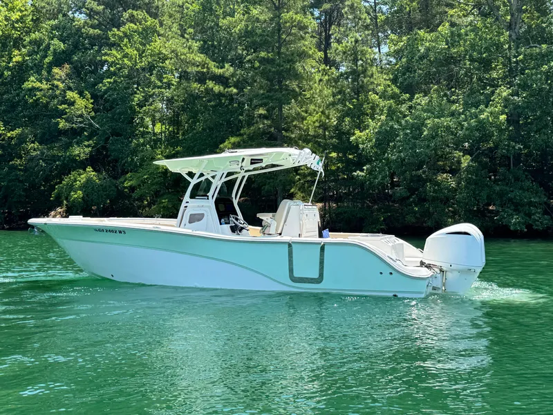 Slide: The Image of 2017 Sea Fox 288 Commander boat on a serene lake with lush green trees. - 7