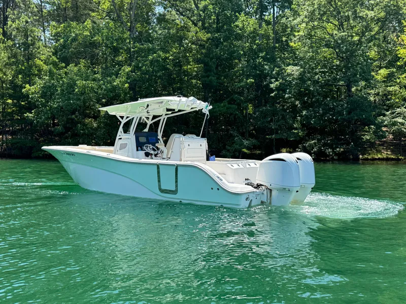 Slide: The Image of 2017 Sea Fox 288 Commander boat cruising on a serene lake with lush green trees. - 9