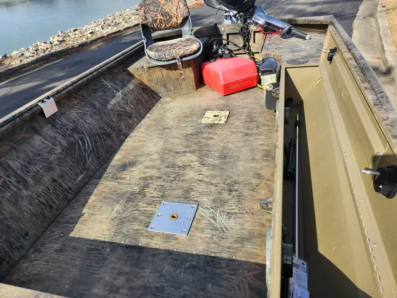Slide: The Image of 2019 G3 Gator Tough 15 DK boat interior with camo seat and red fuel tank. - 15