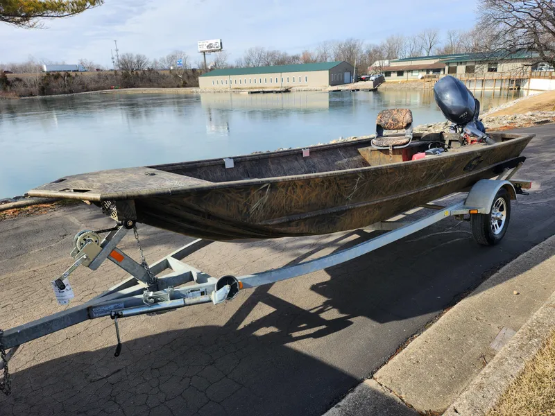 Slide: The Image of 2019 G3 Gator Tough 15 DK boat on trailer by a lake. - 8