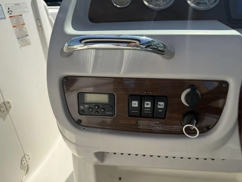Slide: The Image of Control panel of a 2007 Chaparral 276 SSX boat with switches and key ignition. - 10