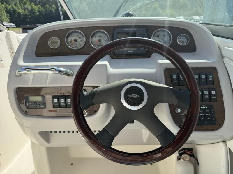 Slide: The Image of Steering wheel and dashboard of 2007 Chaparral 276 SSX boat with gauges and controls. - 12