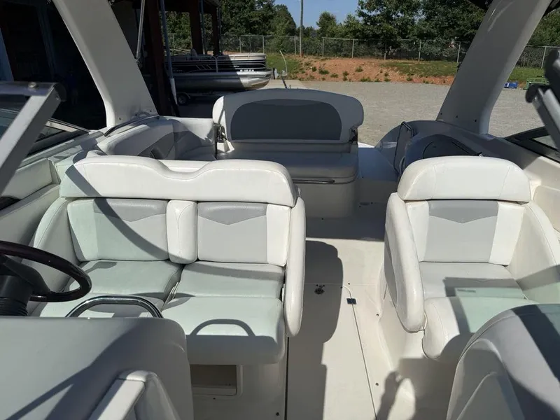 Slide: The Image of 2007 Chaparral 276 SSX boat interior with white seating and steering wheel. - 13