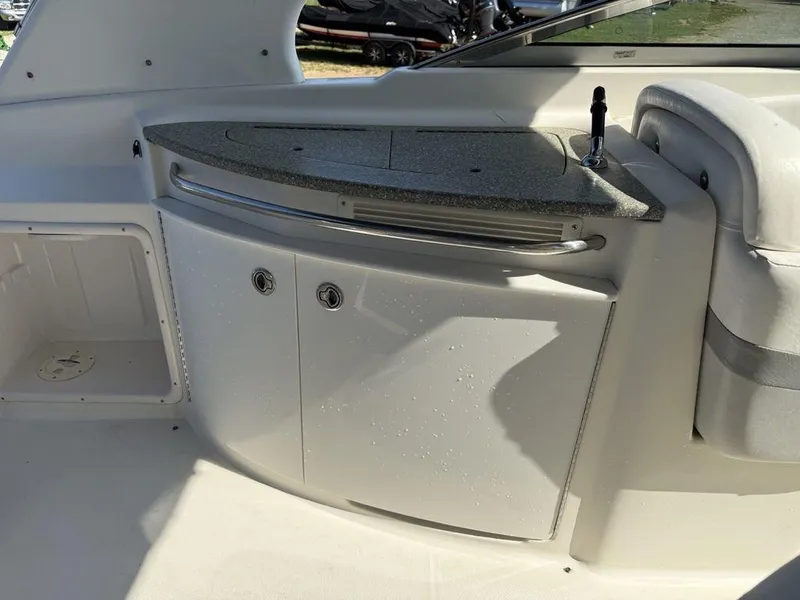 Slide: The Image of 2007 Chaparral 276 SSX boat interior with wet bar and storage cabinets. - 16