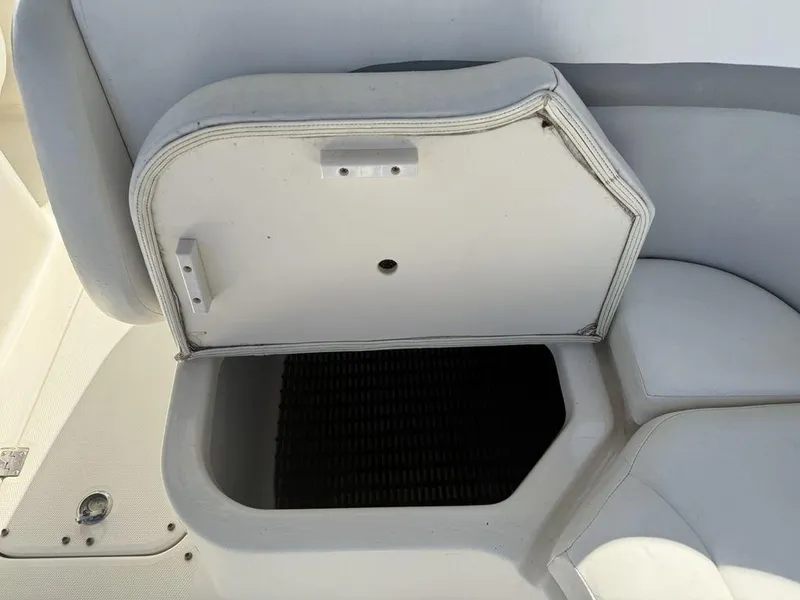 Slide: The Image of Open storage compartment on a 2007 Chaparral 276 SSX boat seat. - 19