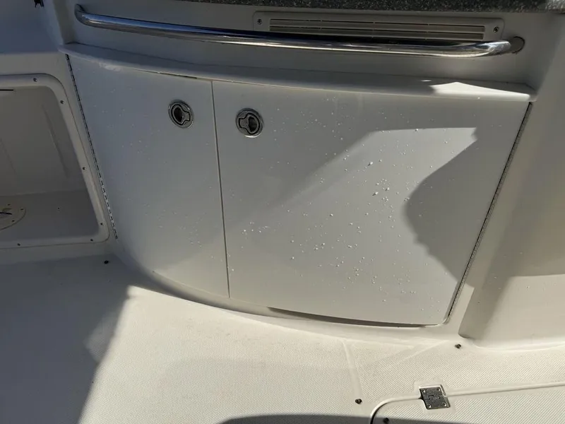 Slide: The Image of 2007 Chaparral 276 SSX boat interior with wet cabinet doors and stainless steel handle. - 21